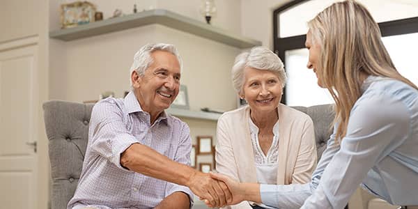 Retited couple shaking hands with advisor